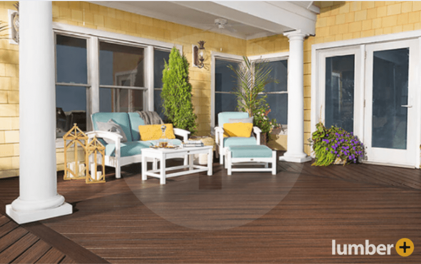 Spiced Rum Trex decking against a yellow house.