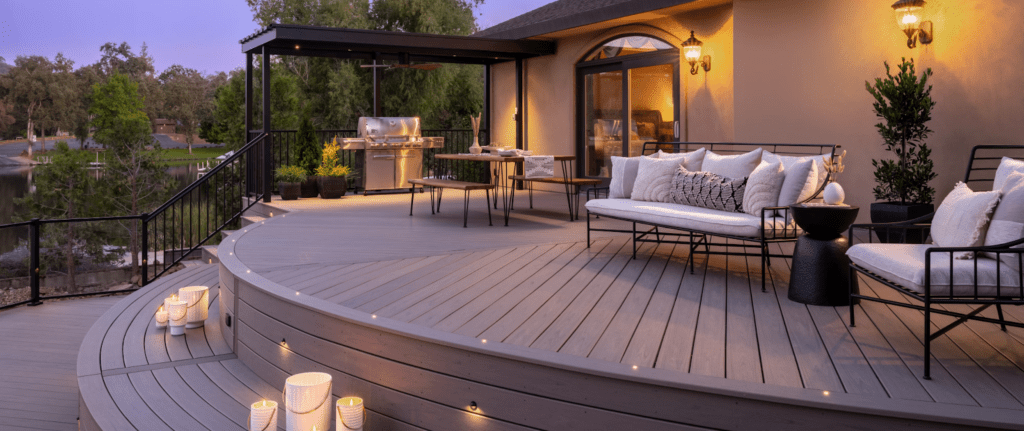 A Trex composite deck patio lit at night, staged for entertaining guests.