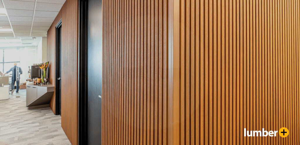 Wooden accent wall inside an office building separating office spaces.