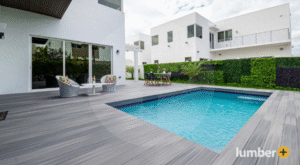 Modern composite deck with pool and contemporary outdoor furniture.
