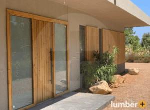 An image of a modern exterior with vertical wood siding and large glass doors.