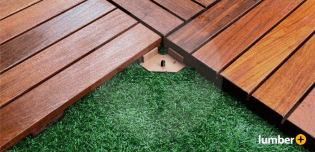 An image showing a close-up of wood deck tiles installed over artificial turf with hidden fasteners.
