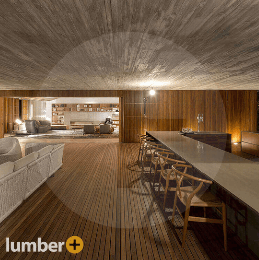 An image of a modern interior with walnut wood flooring and walls, featuring a dining area and lounge.