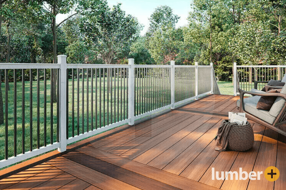 A brown PVC deck in a backyard with trees and cut grass.