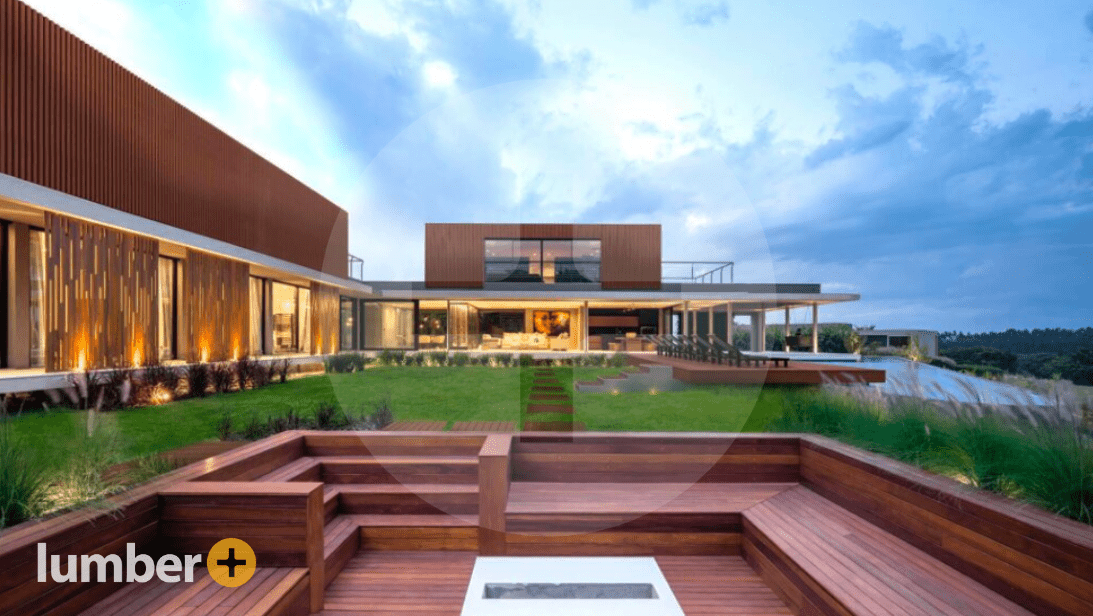 A luxury deck with a wooden walkway that extends to the building.