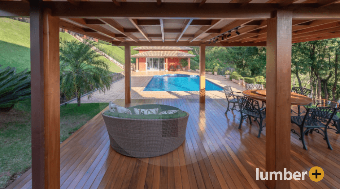 Outdoor luxury deck made out of Angelim wood that is near a small pool of water.